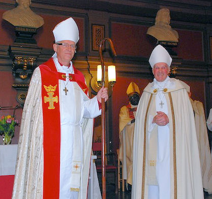Bishop Olsson hands the bishop's staff to Bishop Roland Gustafsson 